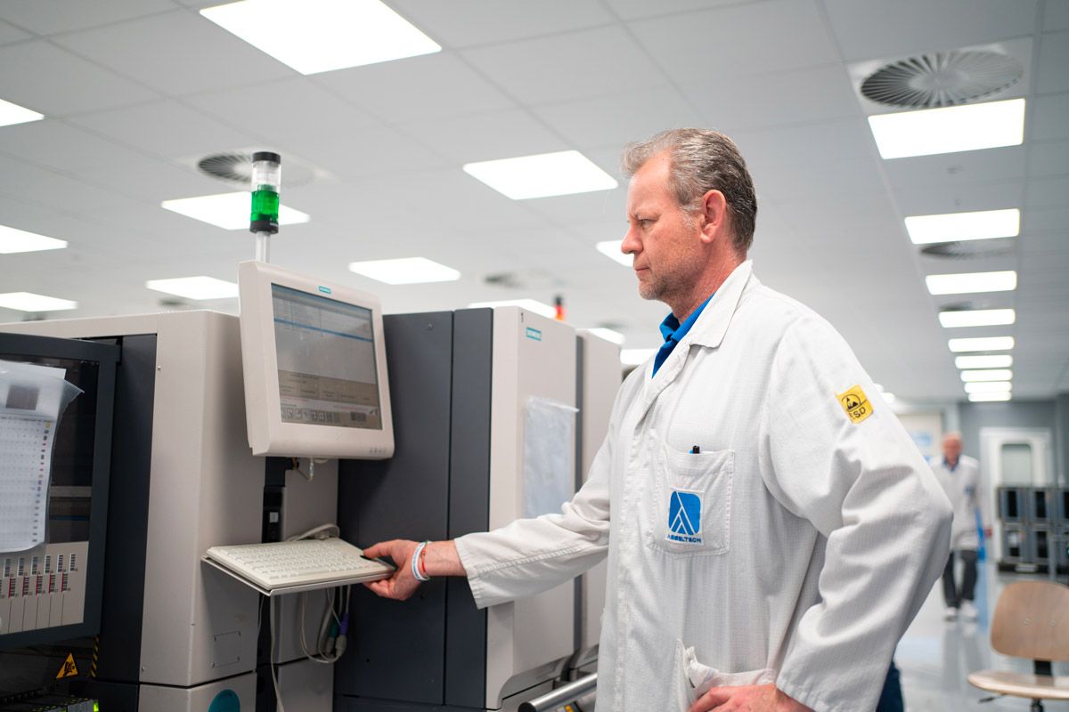 An Asseltech technician at the SMD production line in a clean room